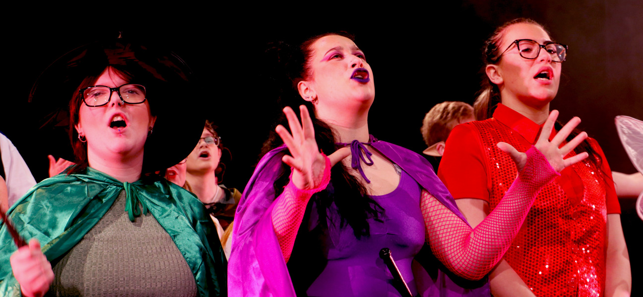 three performing arts students singing
