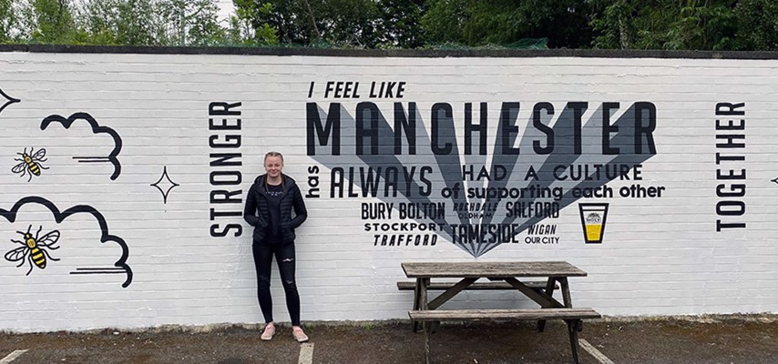 Bury College Level 3 Art and Design stood into front of a painted mural at The Frigate in Whitefield