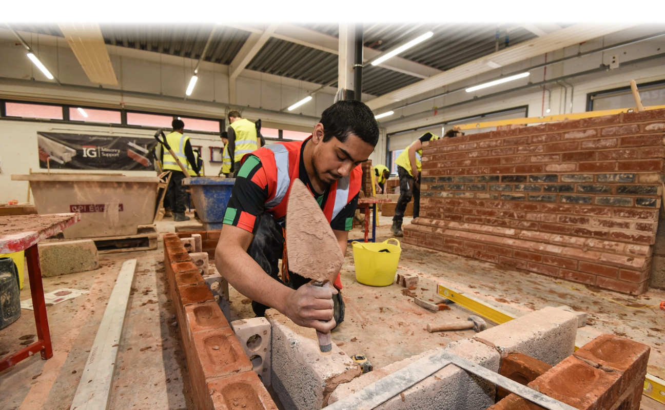 bricklaying student building a brick wall