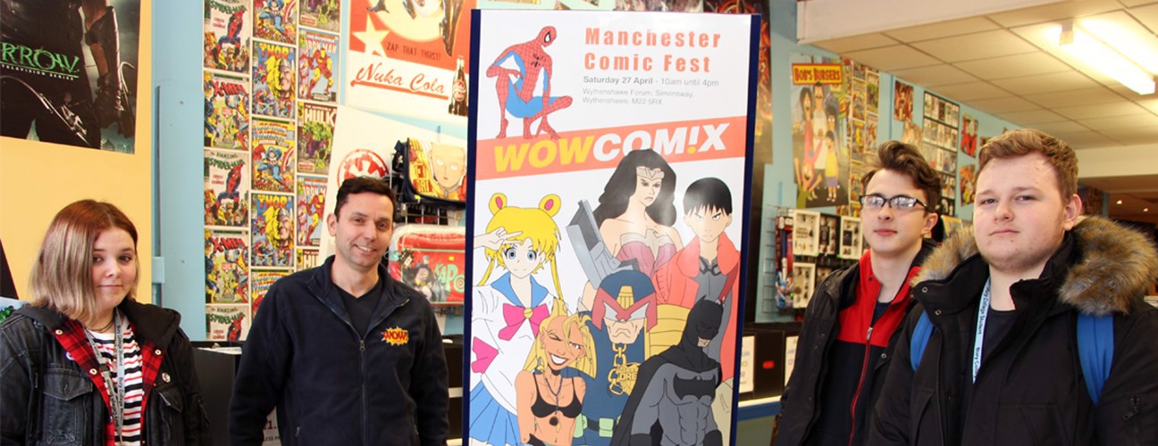 Students stood in front of a banner at Wow Comix