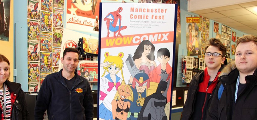Students stood in front of a banner at Wow Comix