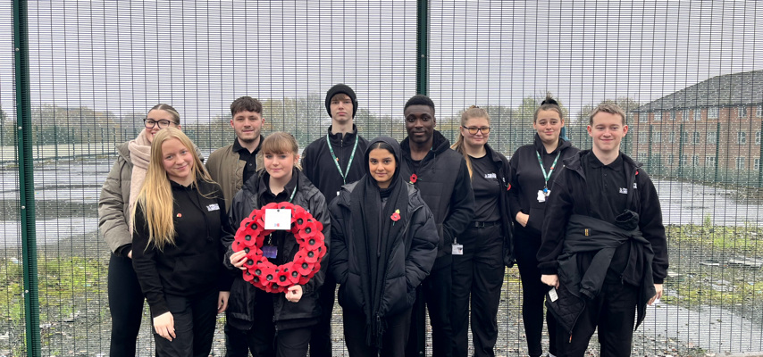 a group of students holding a poppy wreath