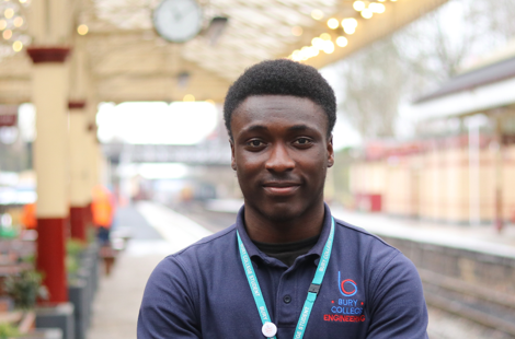 student stood at a train station