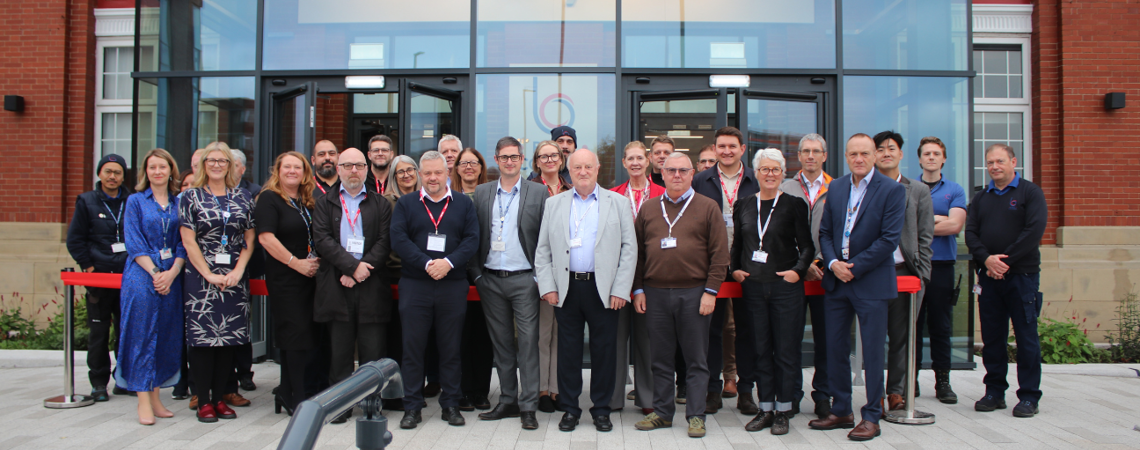 Bury College members of staff and governors stood outside Woodbury building entrance