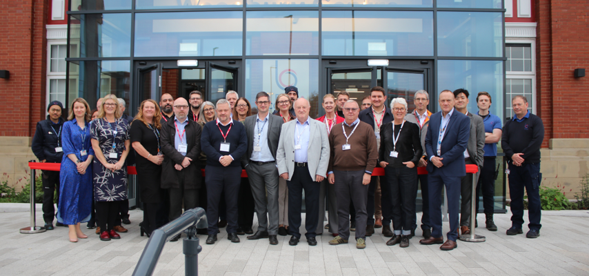Bury College members of staff and governors stood outside Woodbury building entrance