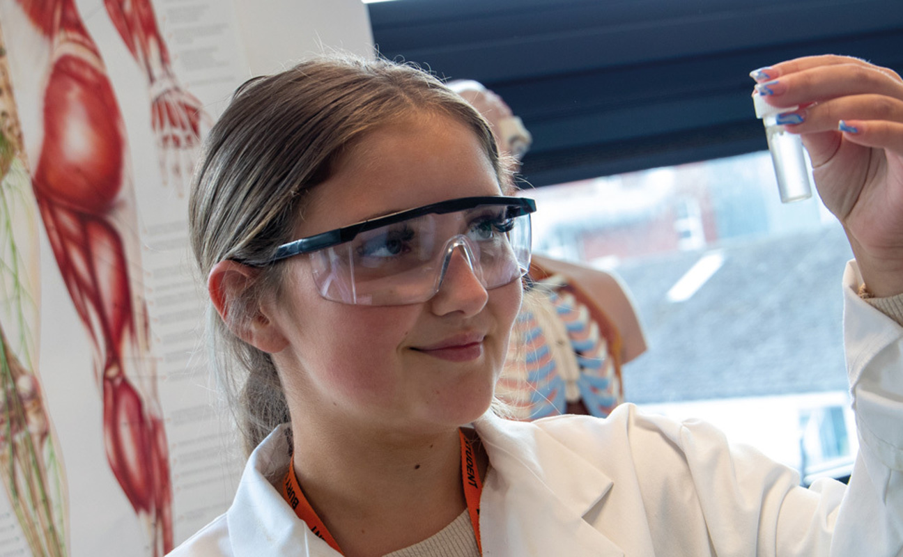 Student holding a science beaker