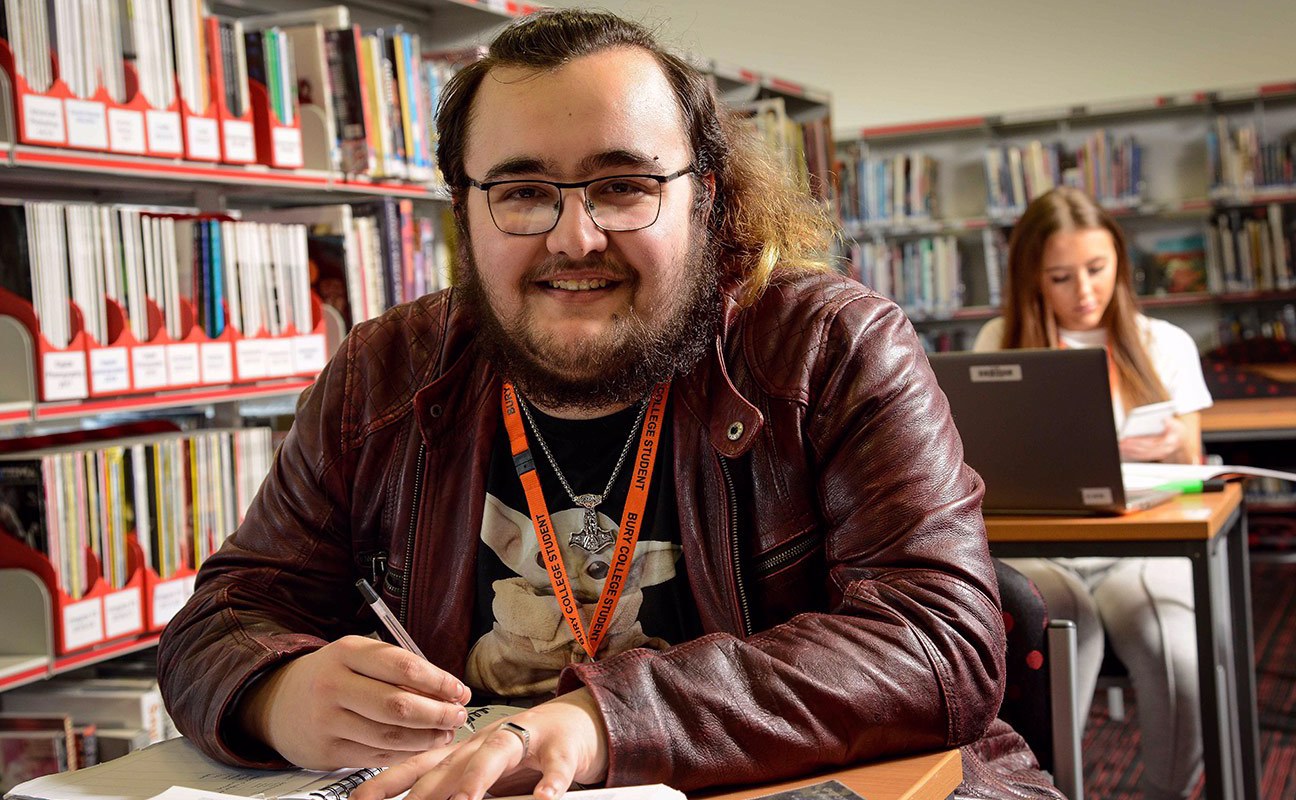 Student smiling to camera in the library