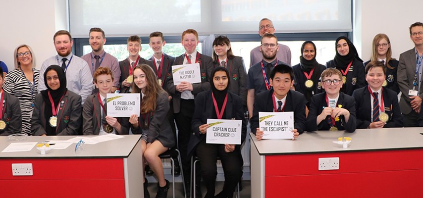 A group of science students holding escape room certificates