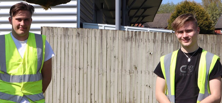 Two Carpentry and Joinery students in high-vis equipment
