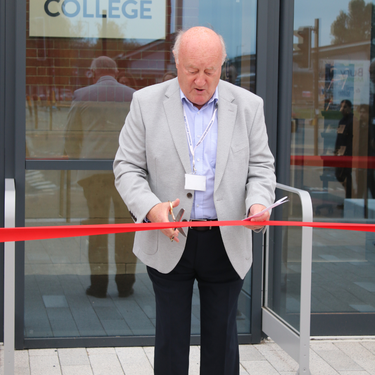 Chris Trees cutting red ribbon