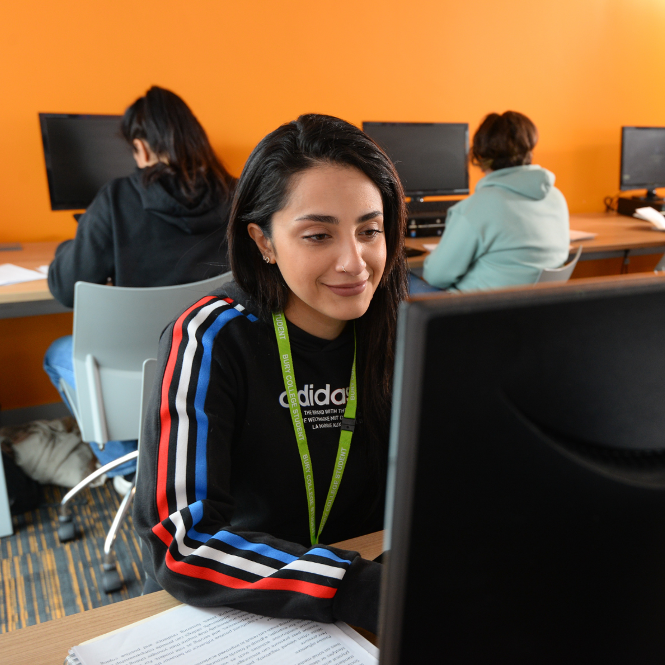 adult learner sat in a classroom at a computer