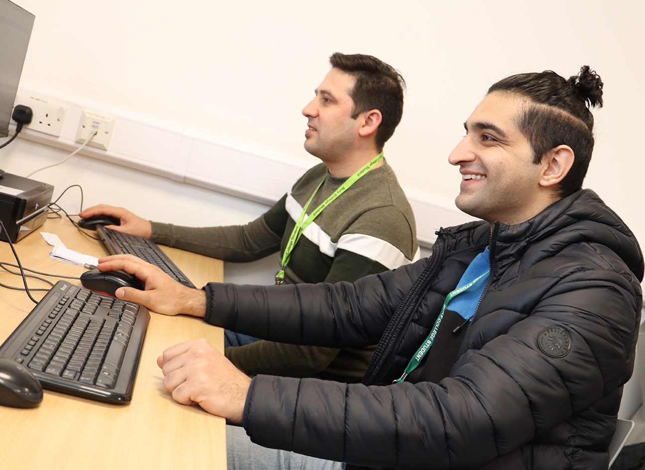 two adult learners using a computer