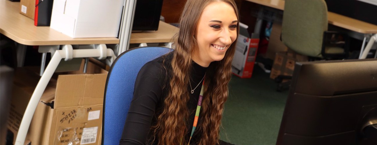 Bury Council Social Media enthusiast, Shannon Wood sat at a desk