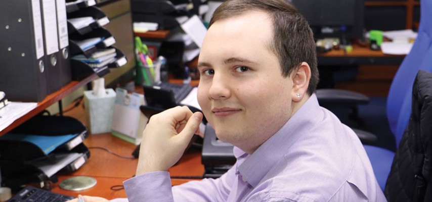 Accounting apprentice, Arran Parker sat at a desk