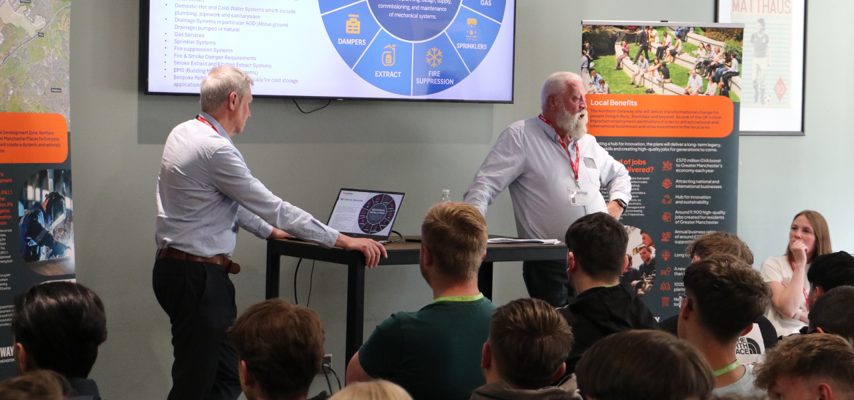 two representatives from northern gateway presenting to a group of students