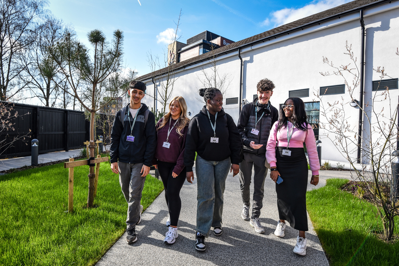 a group of students walking through Woodbury Bistro gardens