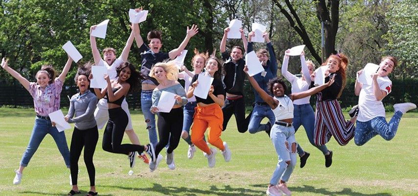 Students jumping in the air, celebrating