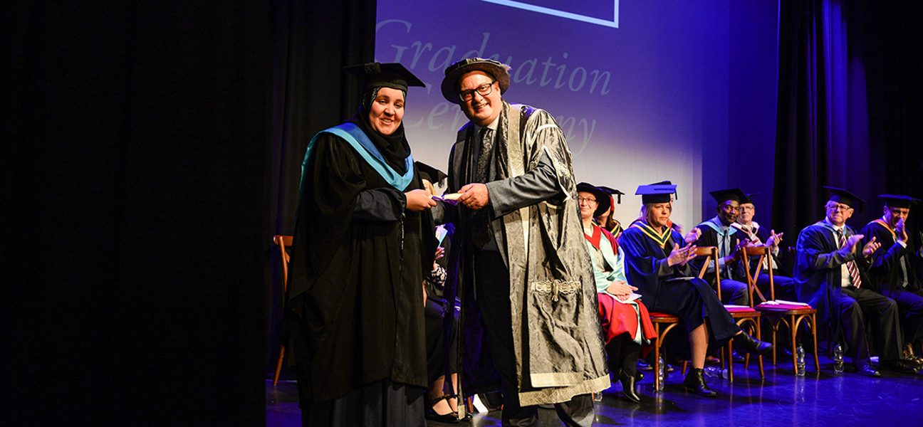 Graduate receiving her diploma on stage