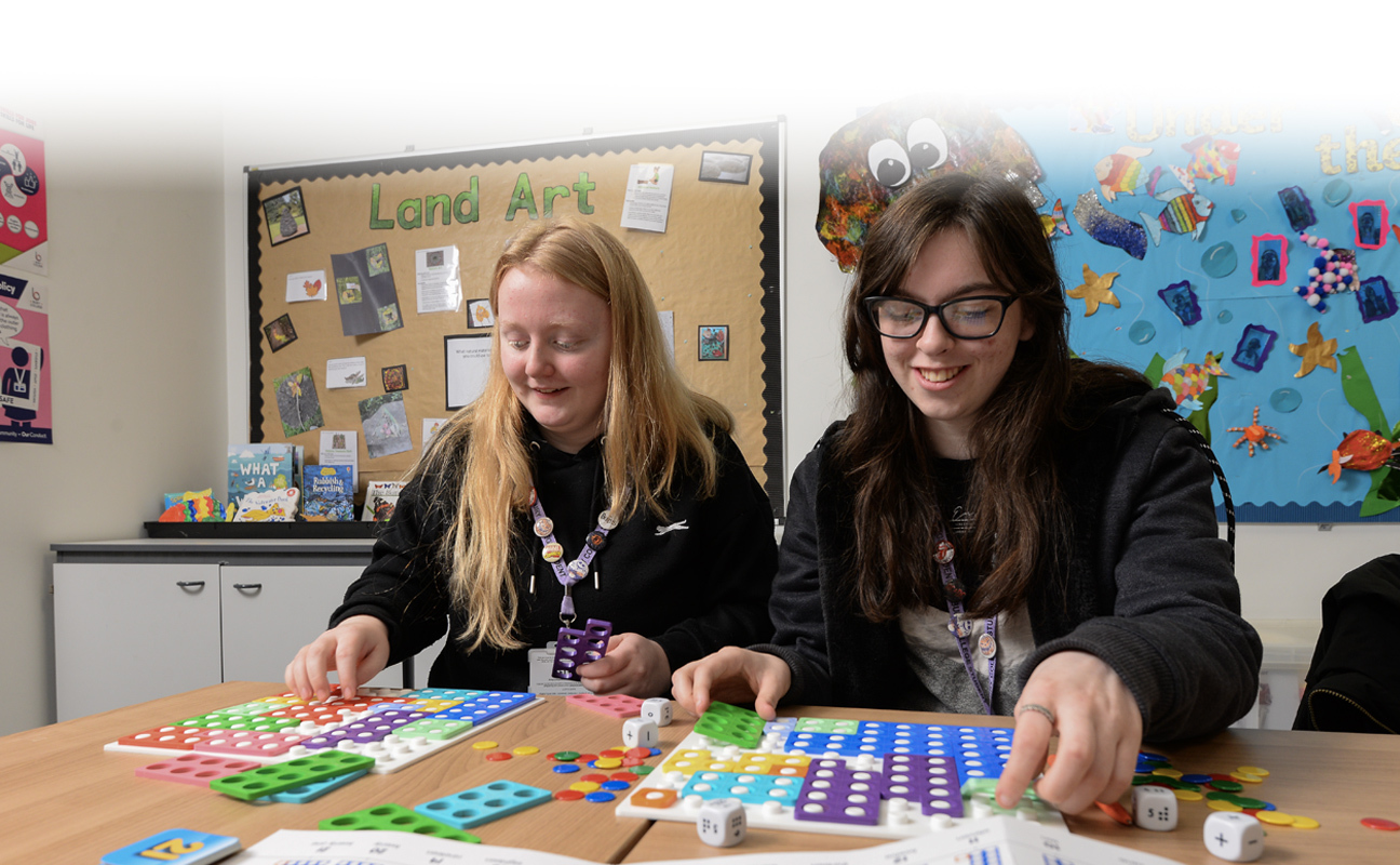 T Level students doing a practical activity in a childcare classroom