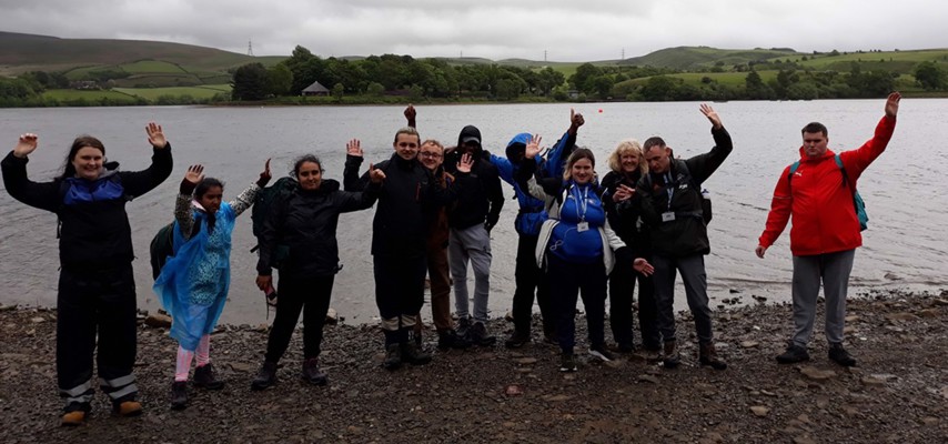 Students from our Moving On, stood in front of a lake