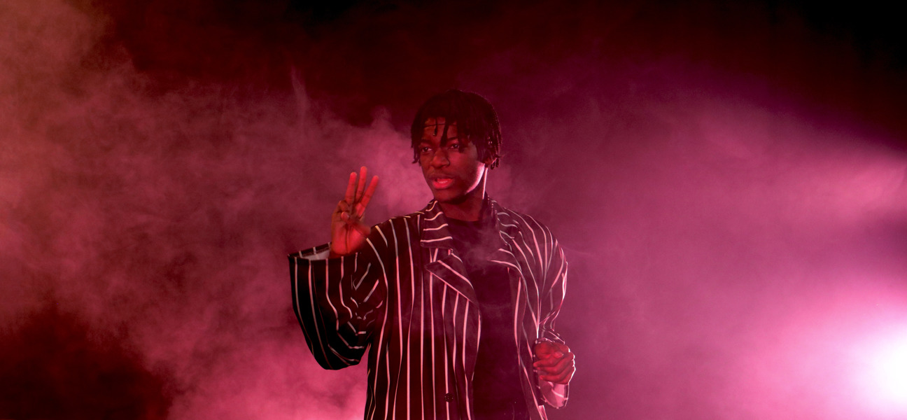 performing arts student in pinstripe shirt