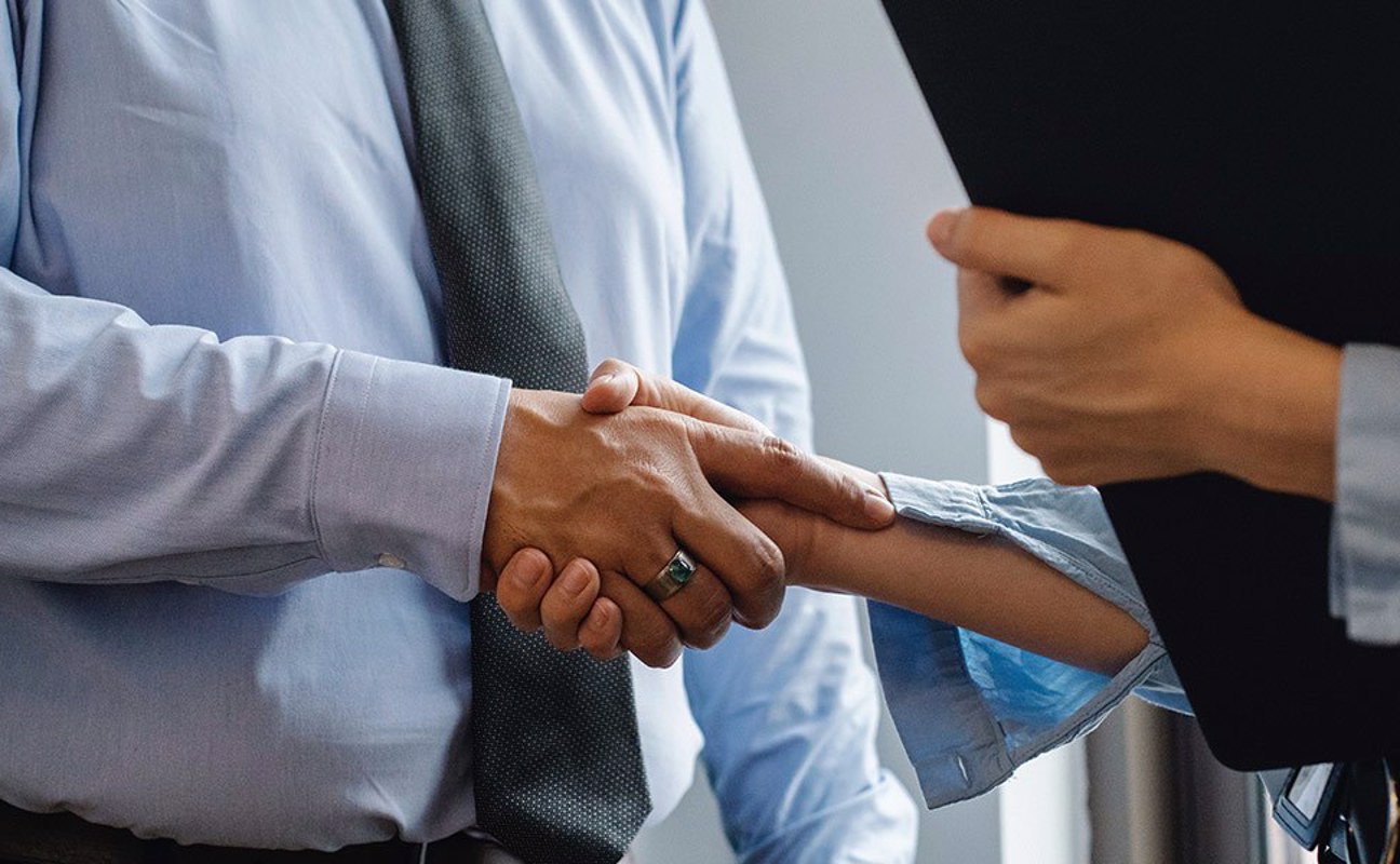Employer Shaking hands with Staff