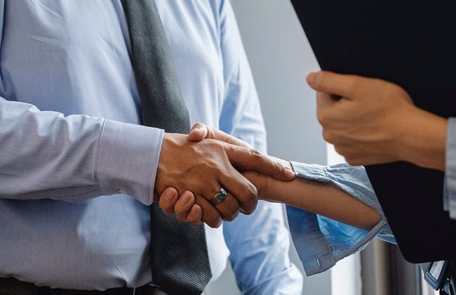 Employer Shaking hands with Staff