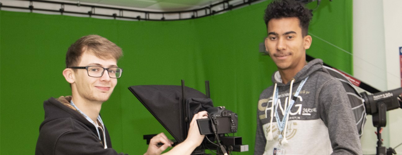 Two students in a green screen studio