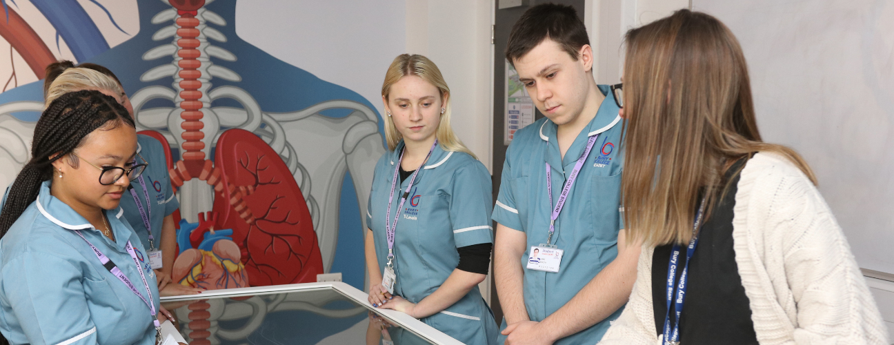 students and tutor stood around an anatomage table