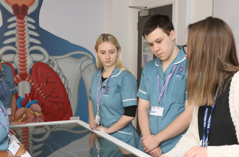 students and tutor stood around an anatomage table