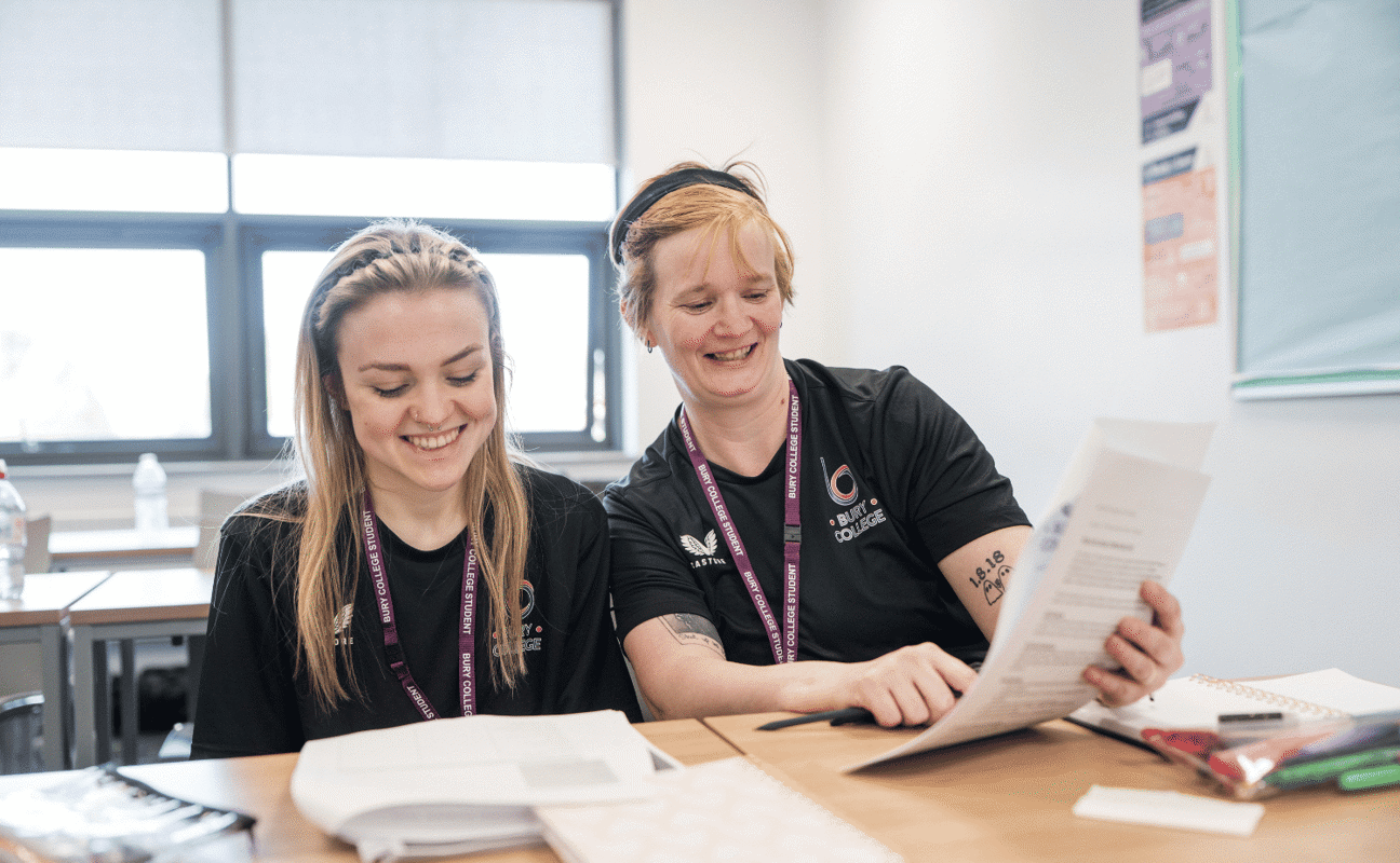 Adult learners smiling in class