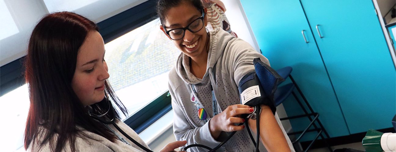 Bury College A-level Science student having her blood pressure measured