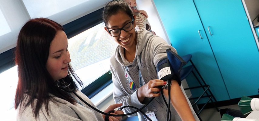 Bury College A-level Science student having her blood pressure measured