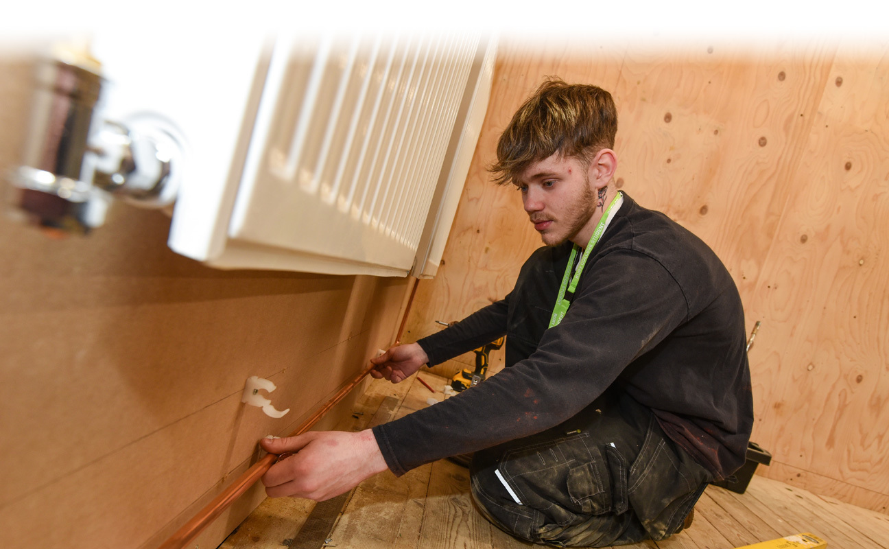 Plumbing student taking part in a practical activity