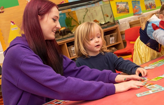Childcare apprentice playing with a student