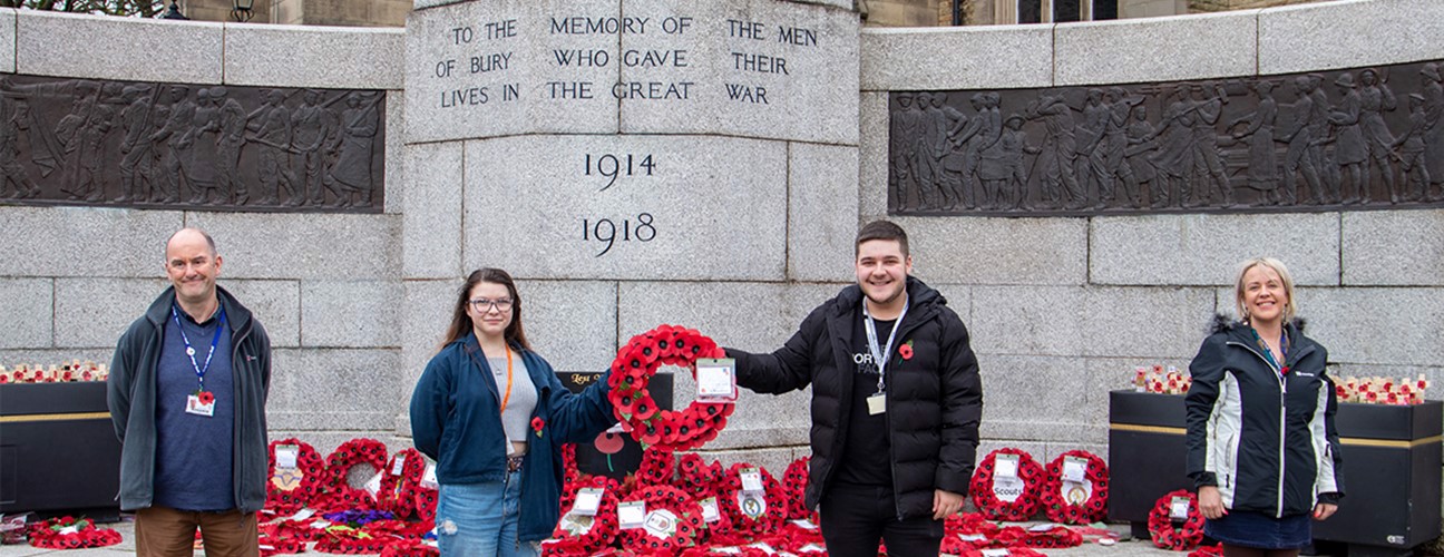 Students stood at the cenotaph in Bury with a Poppy wreath