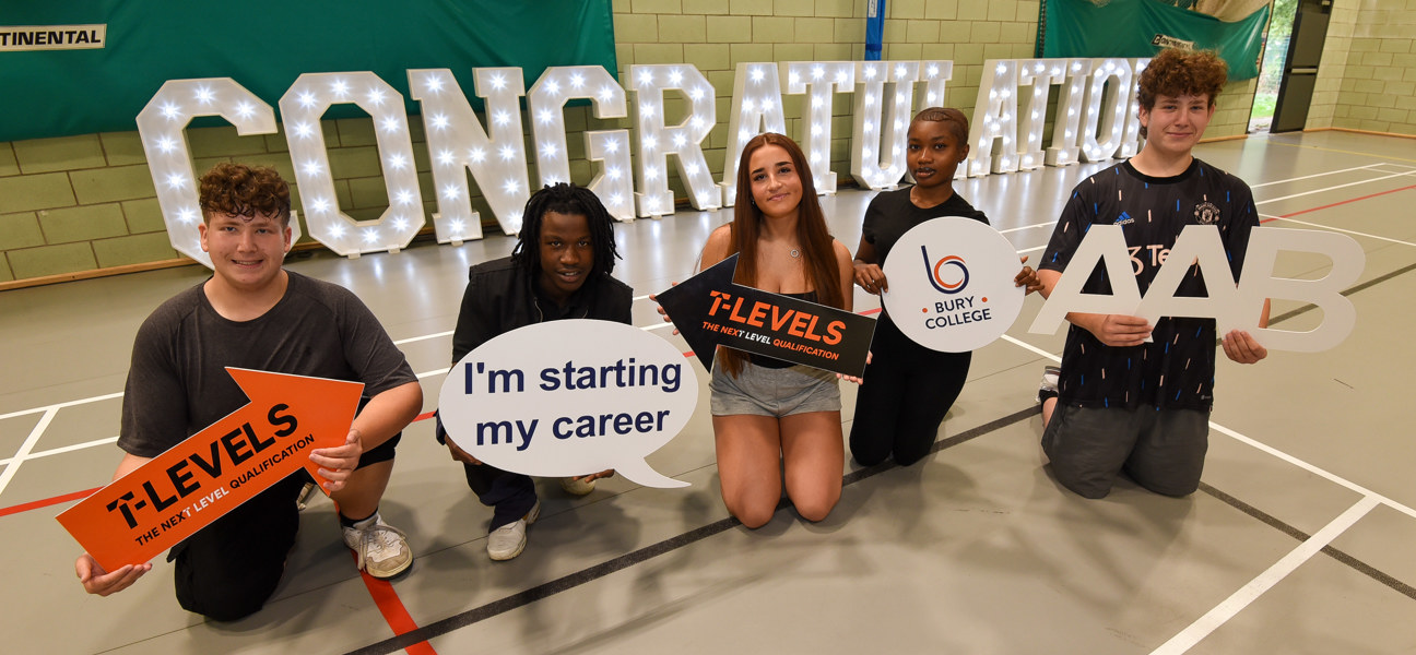a row of students in front of a congratulations sign whilst smiling