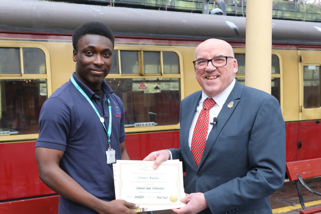 student collecting an award from an employer