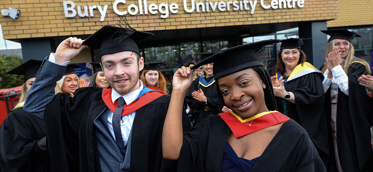 male and female graduate tipping their hats