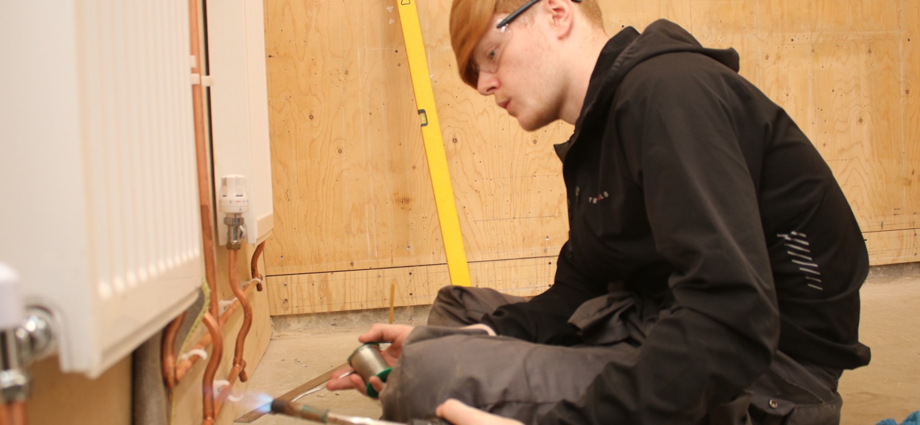 Plumbing student soldering a pipe