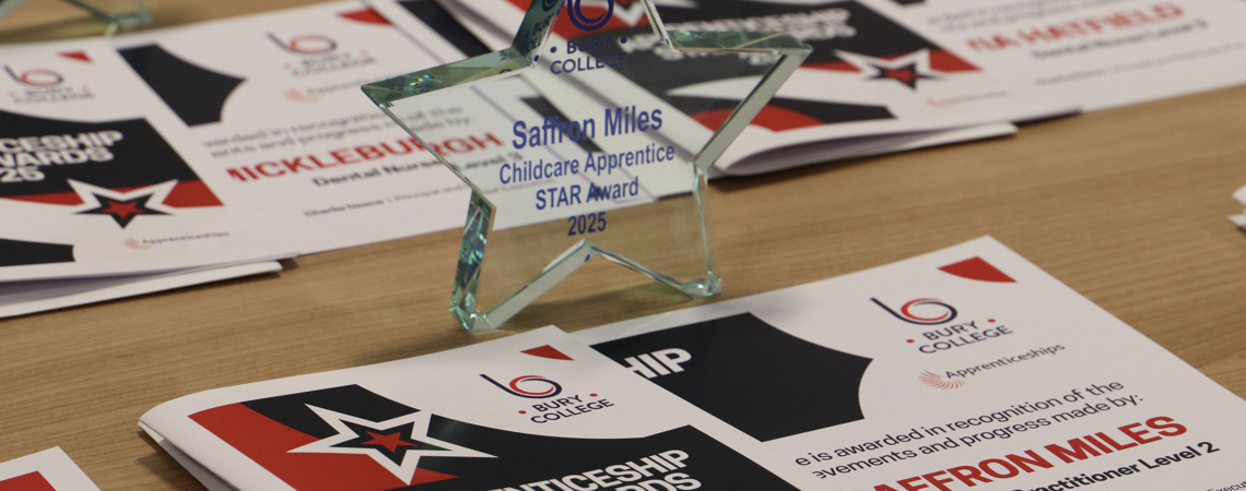 star shaped glass trophy on a table with certificates