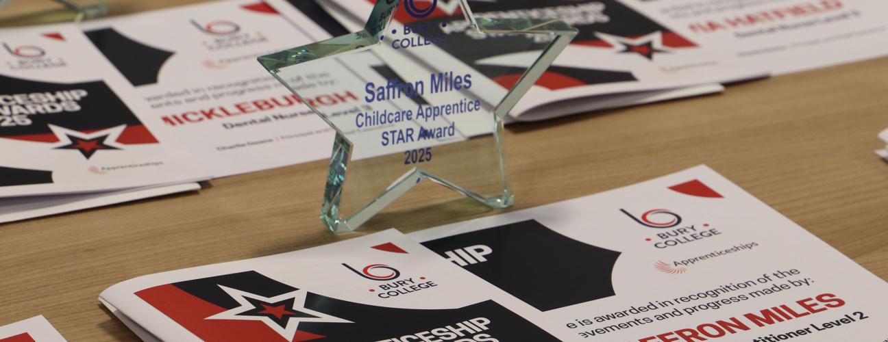 star shaped glass trophy on a table with certificates