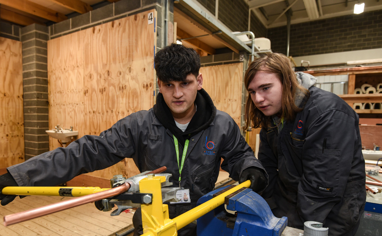 Plumbing students taking part in a practical activity