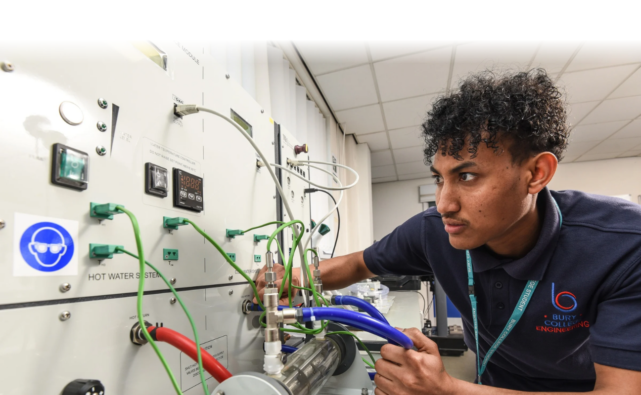 engineering student in a classroom analysing an electrical board