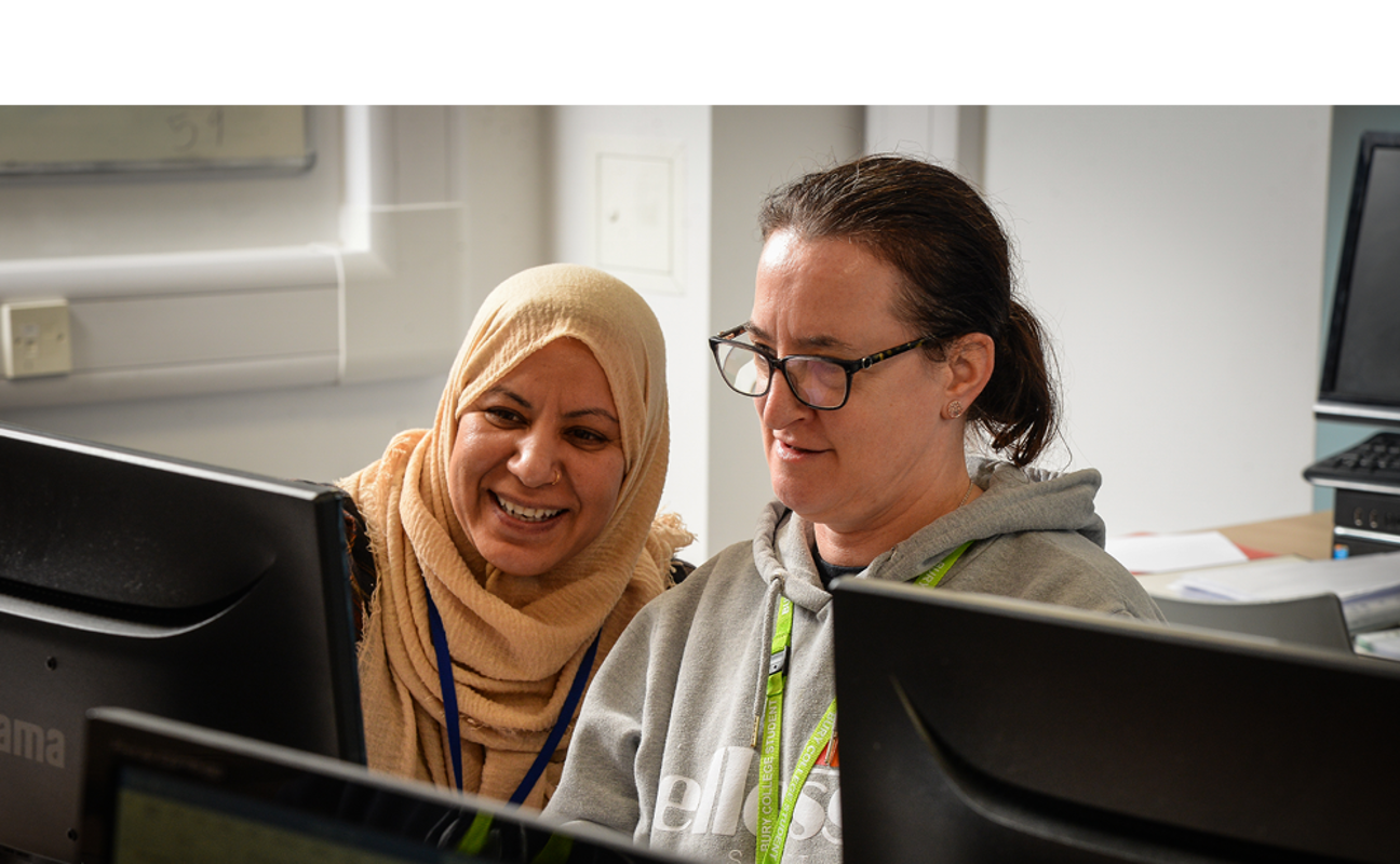 Two adult learners using a computer 