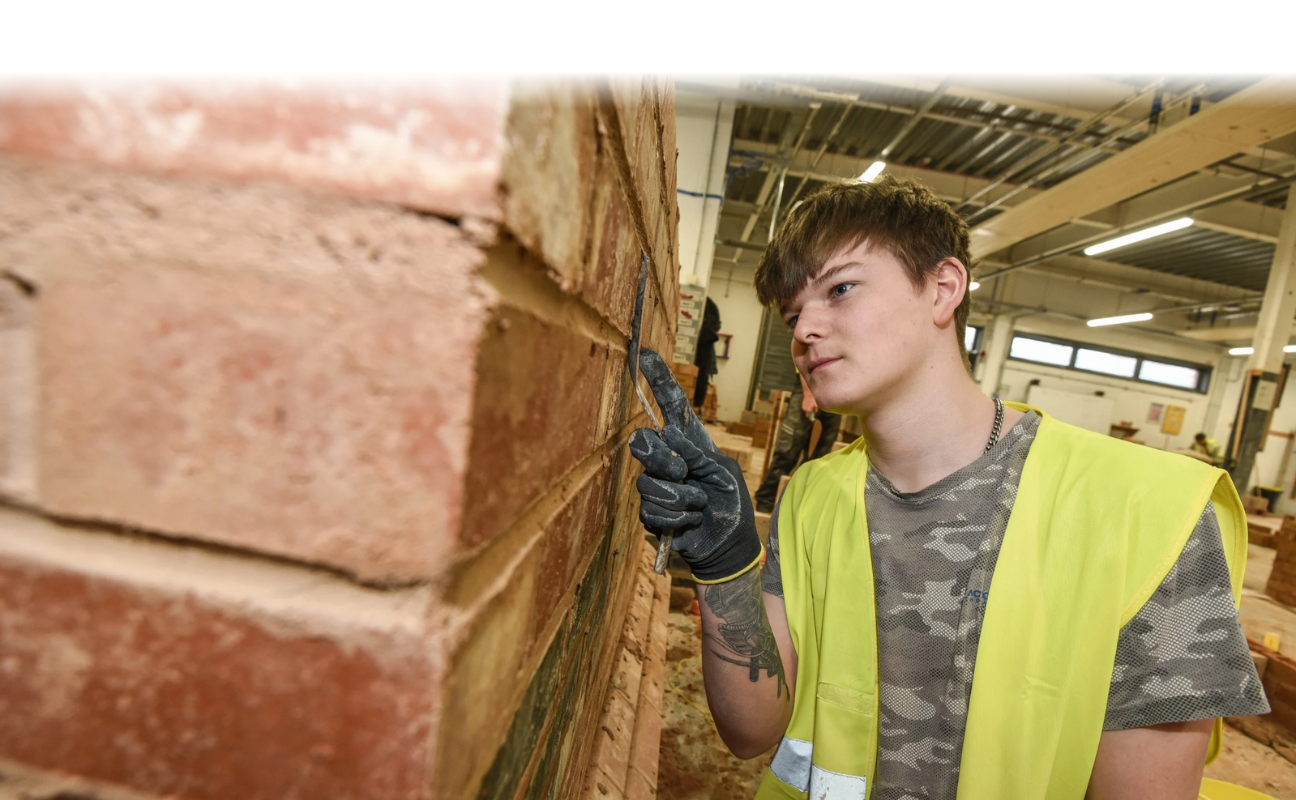 bricklaying student doing some work to a wall