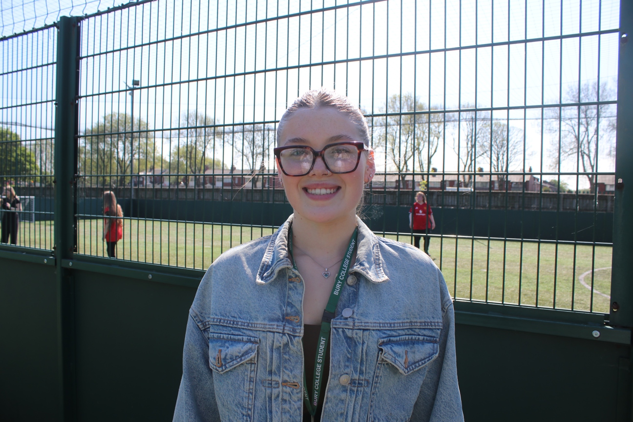 image of student stood in front of sports playing fields