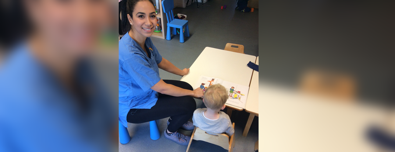 Salma Choukri sat with a child at Swans Care and Education