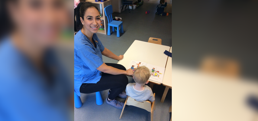 Salma Choukri sat with a child at Swans Care and Education