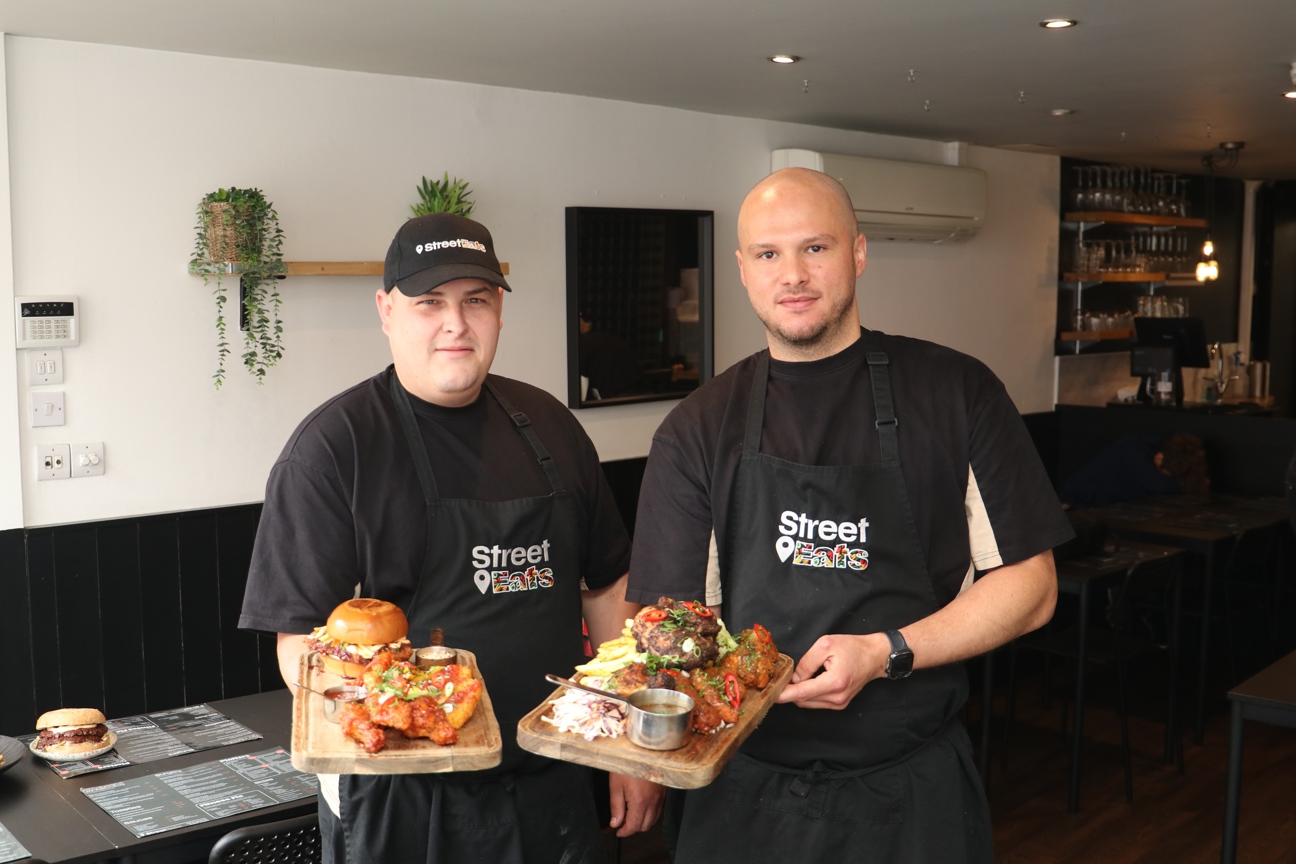 The owners of Street Eats holding food they've made
